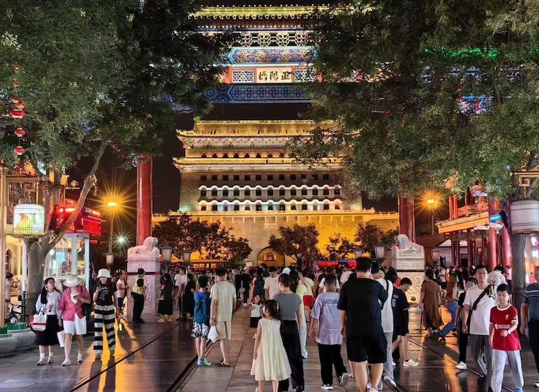 A traditional Chinese building with ornate architecture and a crowd of people in front. 1