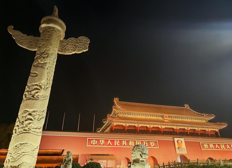 A traditional Chinese building with ornate architecture and a large dragon statue in the foreground. 2