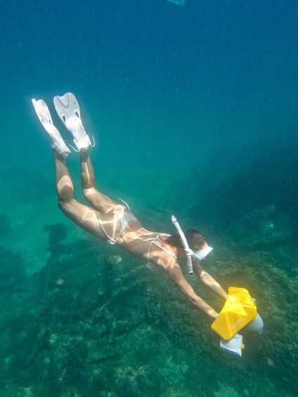 A person scuba diving underwater. 1