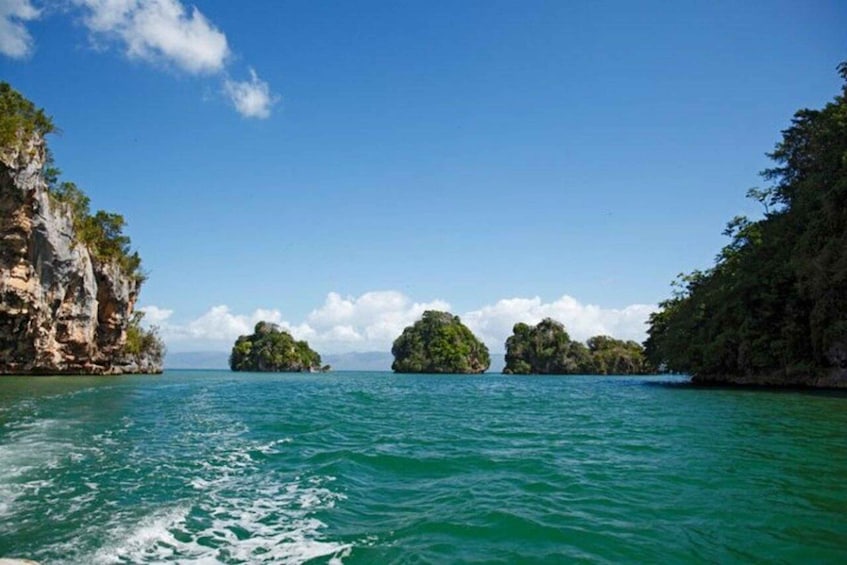 A clear blue sea with rocky cliffs and small islands. 4