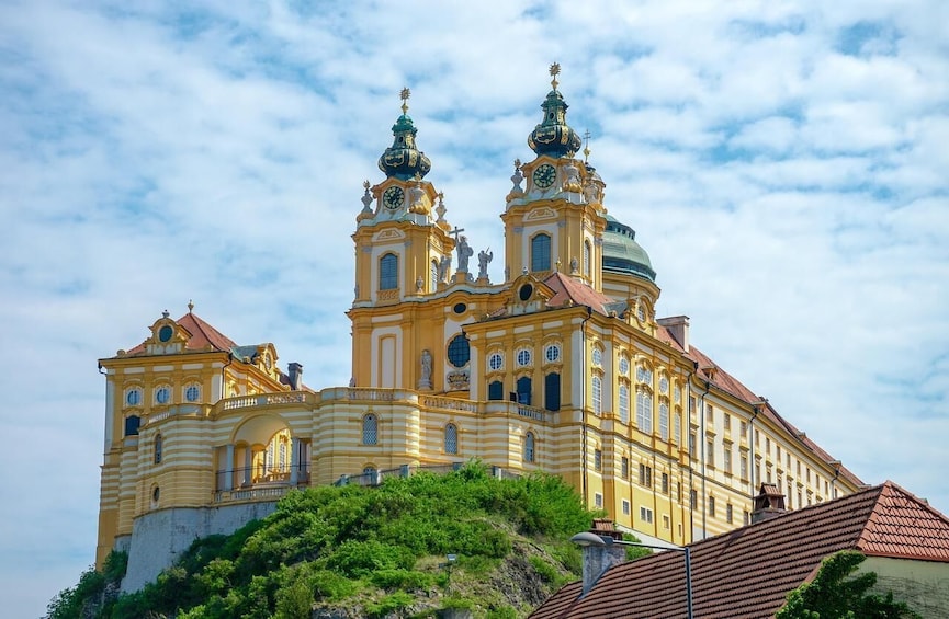 A large yellow church with two towers and a dome. 2