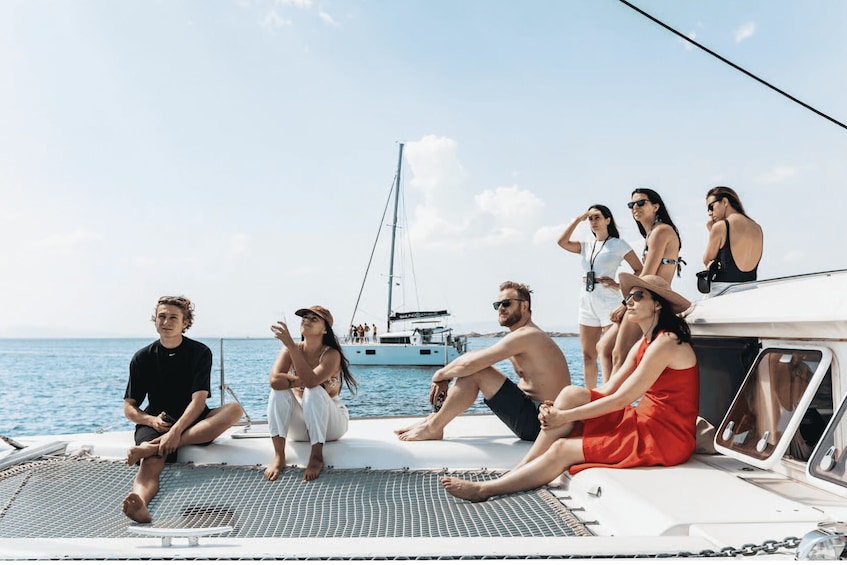 A group of people on a boat with the ocean in the background. 2