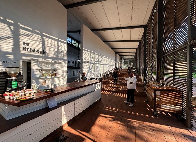 An interior of a café with a bar area, wooden slatted walls, and a tiled floor. 4