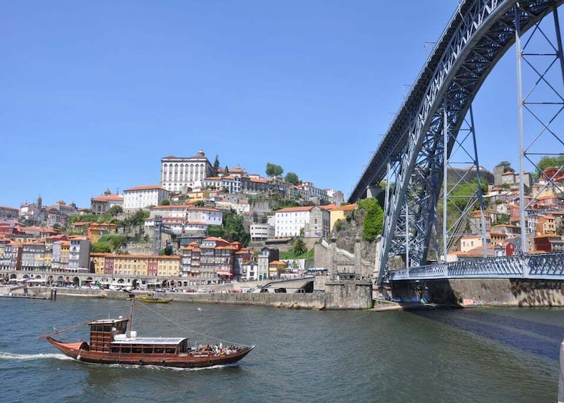 A river with a boat, a bridge, and a cityscape with historic buildings. 1