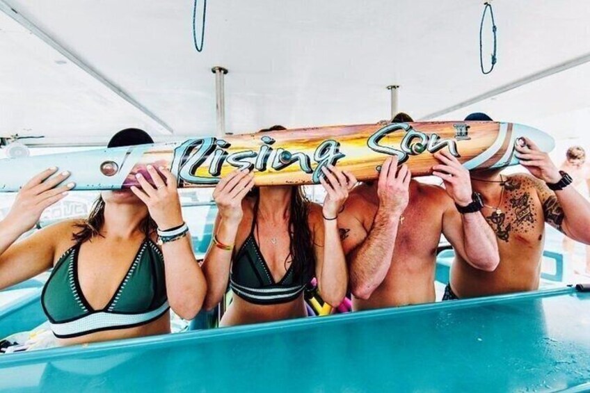 People holding a surfboard in a pool. 3