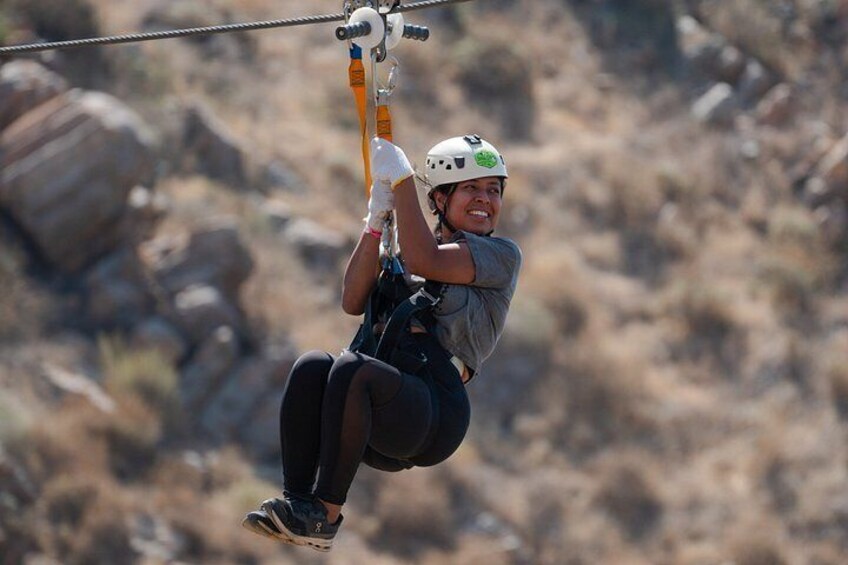 A person zip-lining through a rocky landscape. 2