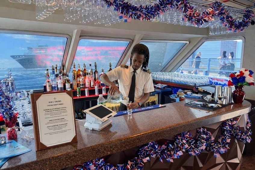 A bar on a cruise ship with a bartender preparing a drink, surrounded by bottles and glasses. 3