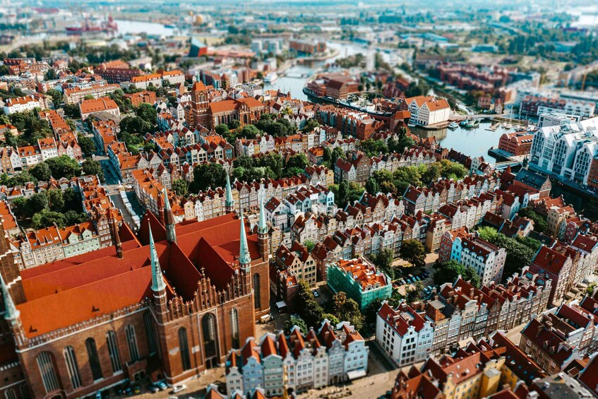 A panoramic view of a historic city with dense architecture, a prominent church, and a river. 3