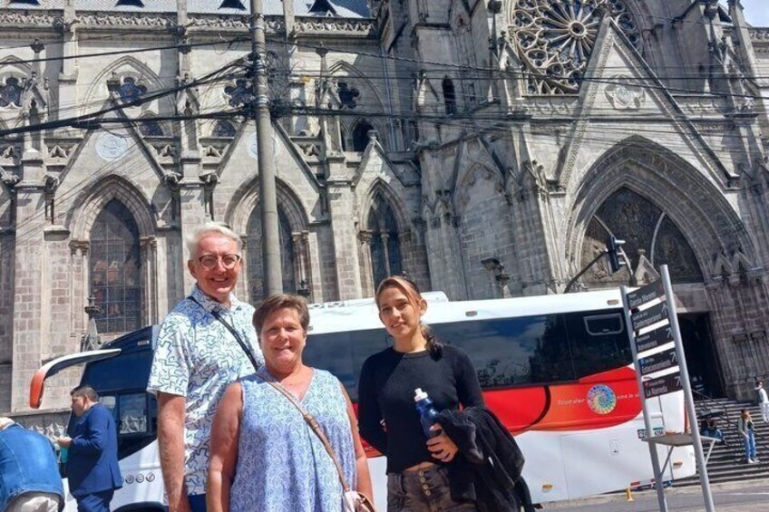 A historic cathedral with intricate gothic architecture, a bus, and a person holding a water bottle. 5