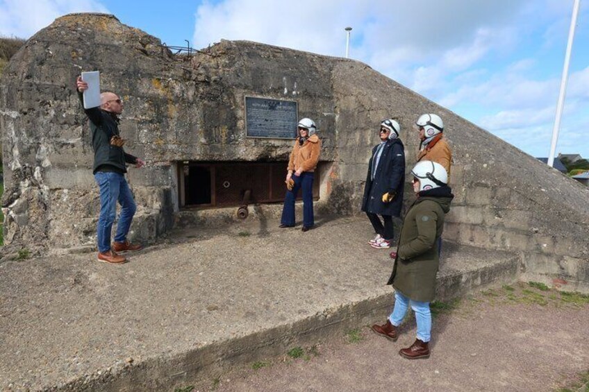 A group of people standing on a concrete platform with a historical building in the background. 2