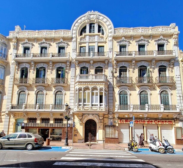 A historic building with ornate balconies and a central archway. 2