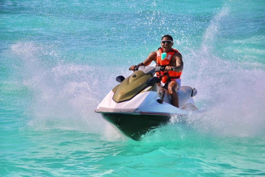 A person riding a jet ski on turquoise water. 3