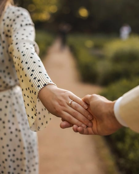 Two hands holding hands on a path. 4
