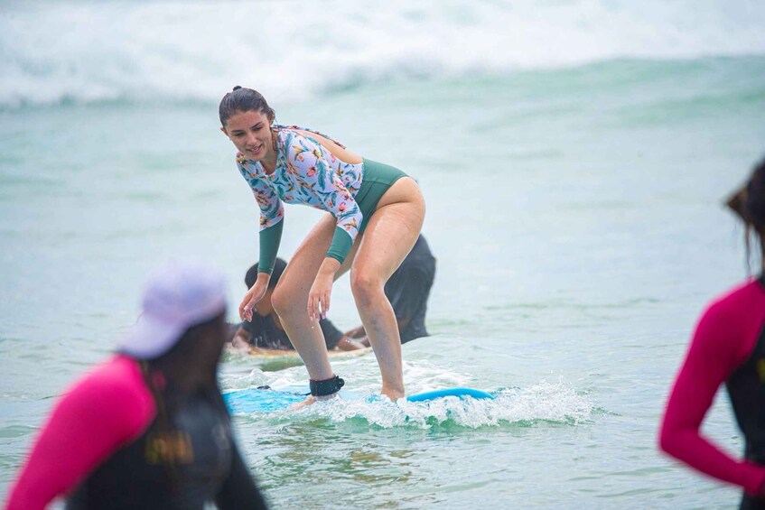 A person surfing on a wave in the ocean. 5