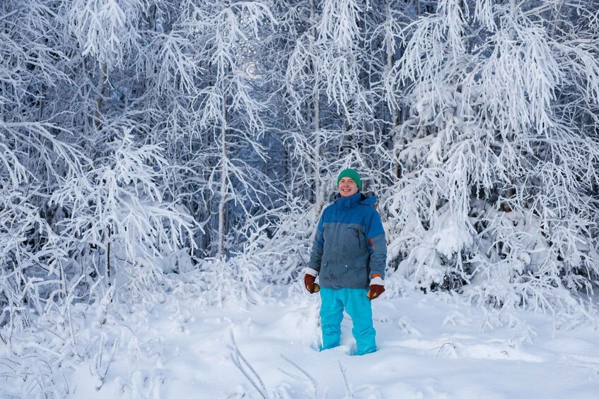 A person standing in a snowy forest. 2