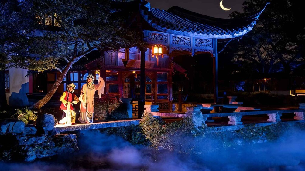 A traditional Chinese pavilion at night with illuminated windows and a crescent moon in the sky. 5