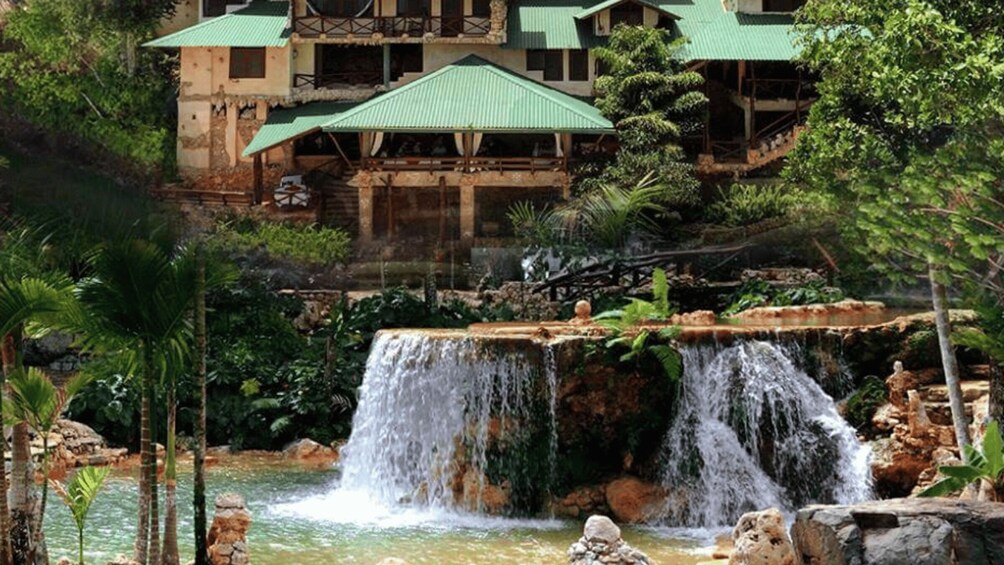 A waterfall, a pool, and a building with green roofs. 4