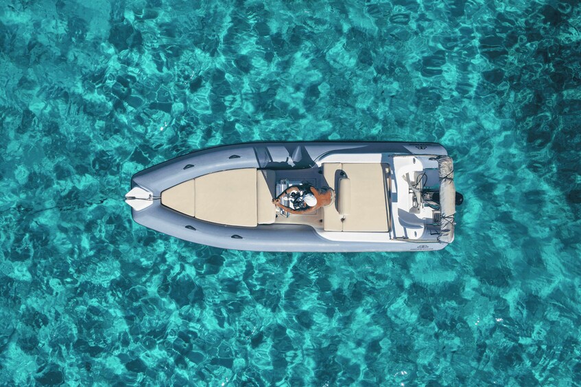 A small motorboat on clear turquoise water. 3