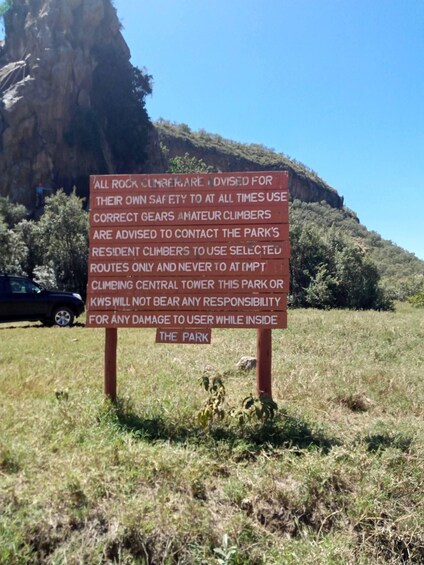 A warning sign for rock climbers in a natural setting. 3