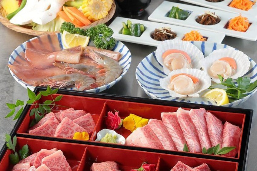 A variety of seafood including shrimp, scallops, and fish, along with some vegetables and herbs. 1