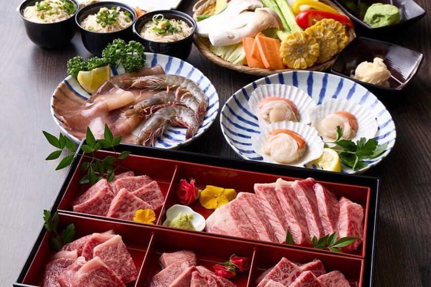 A variety of Japanese dishes including sashimi, sushi, and meat. 5