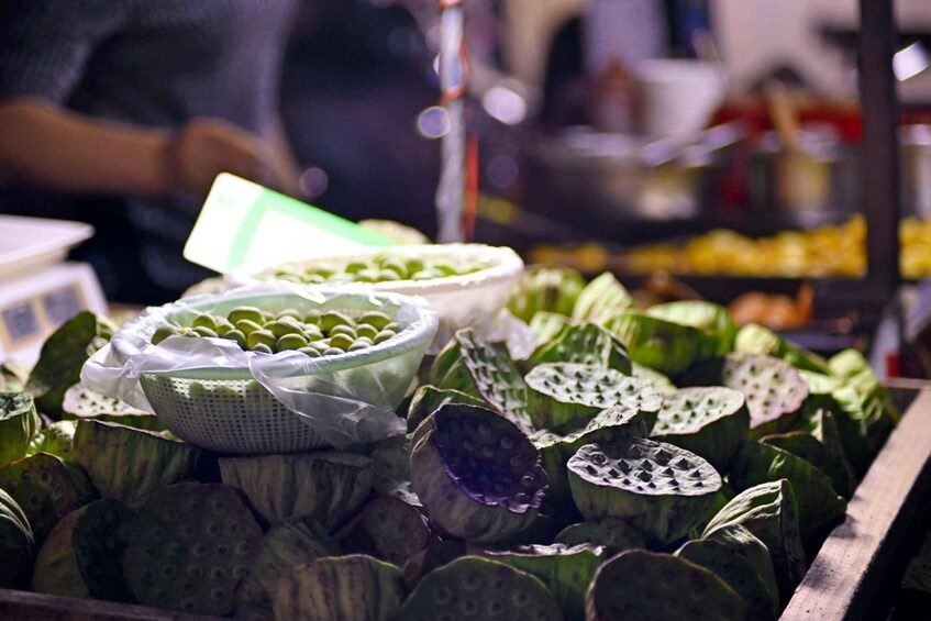 A market stall with lotus leaves and green lotus buds. 2