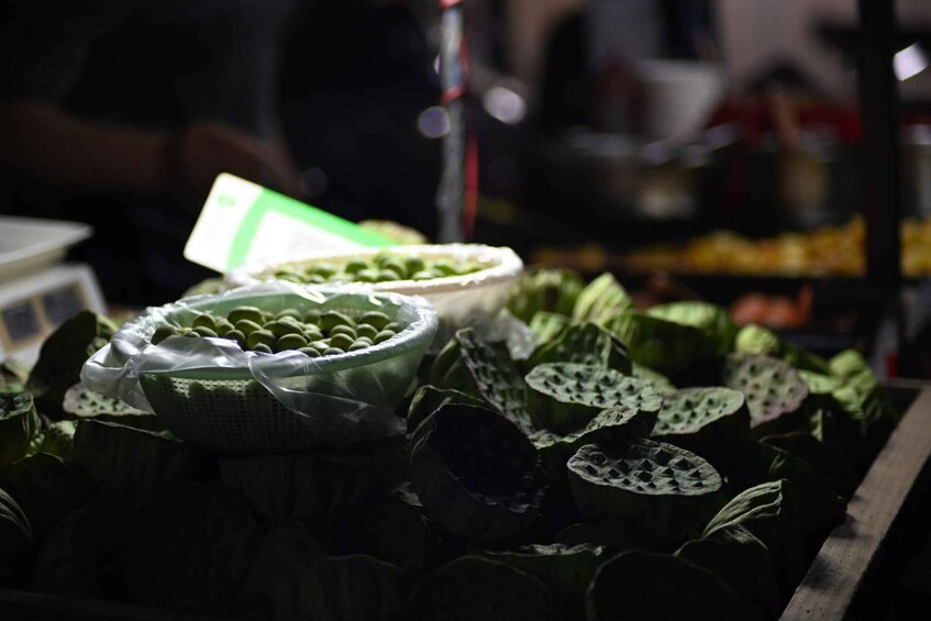A display of lotus leaves and pods at a market stall. 5