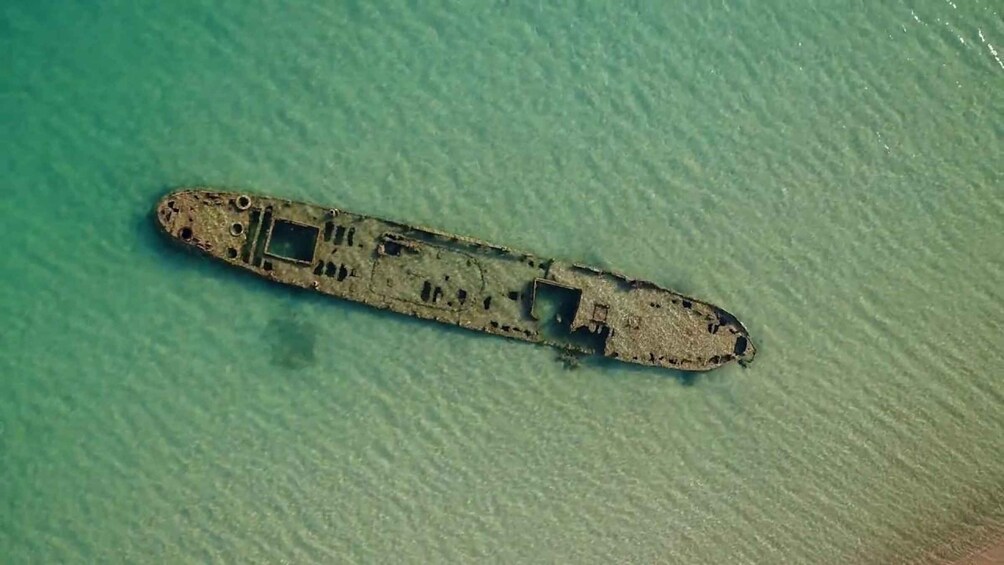 An abandoned shipwreck on a clear turquoise sea. 5