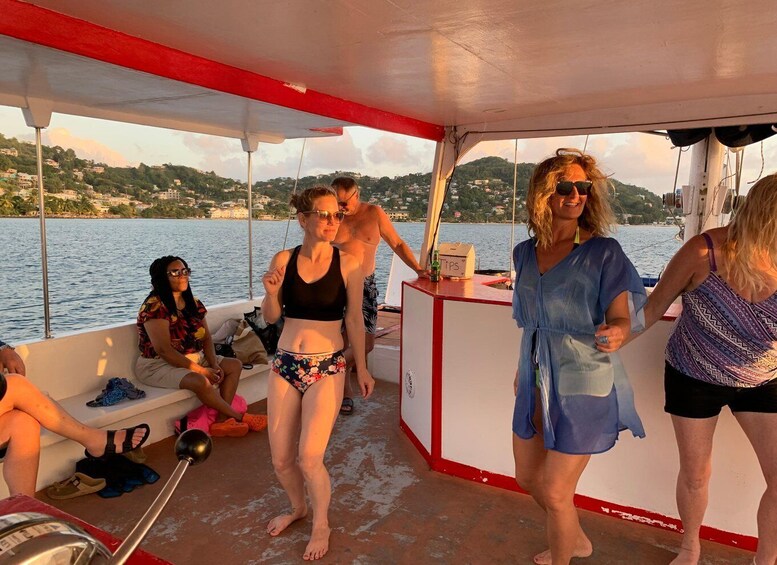 A group of people on a boat with a red and white cabin, a person in a floral swimsuit, and a landscape with hills and water in the background. 3