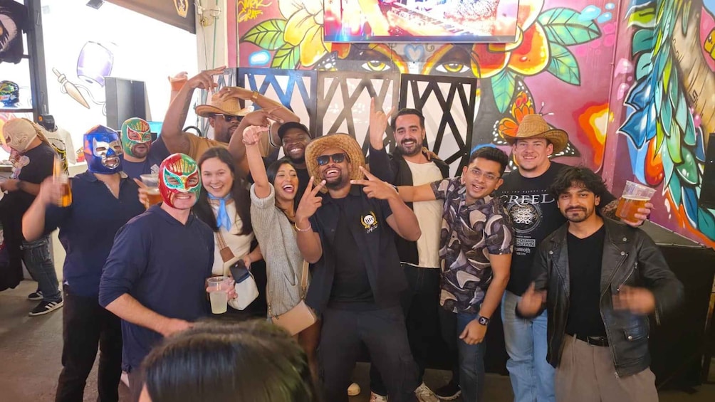 A group of people at a lively event with colorful graffiti on the walls. 5