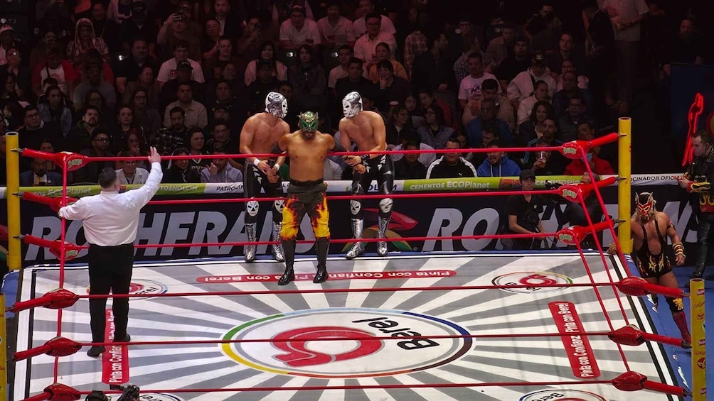 A wrestling ring with a crowd in the background. 1