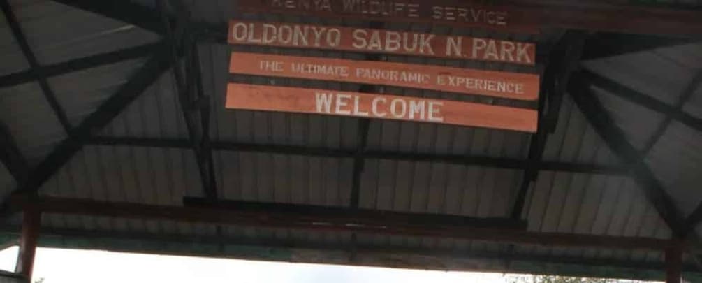 A sign for Oldenyo Sabuk N. Park welcoming visitors. 1