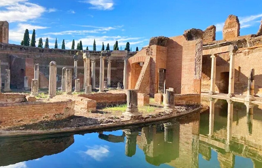 Ancient ruins with columns and a reflecting pool. 5