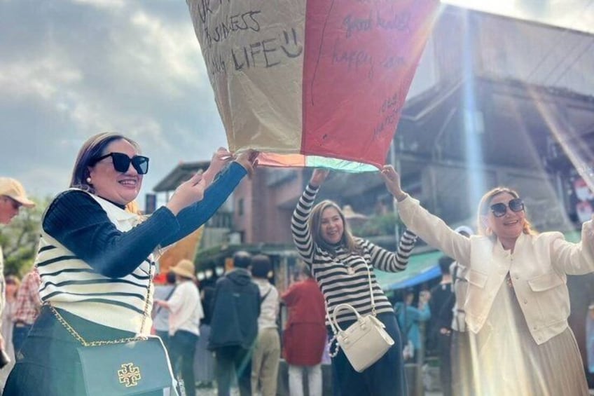 People holding a banner with text. 1