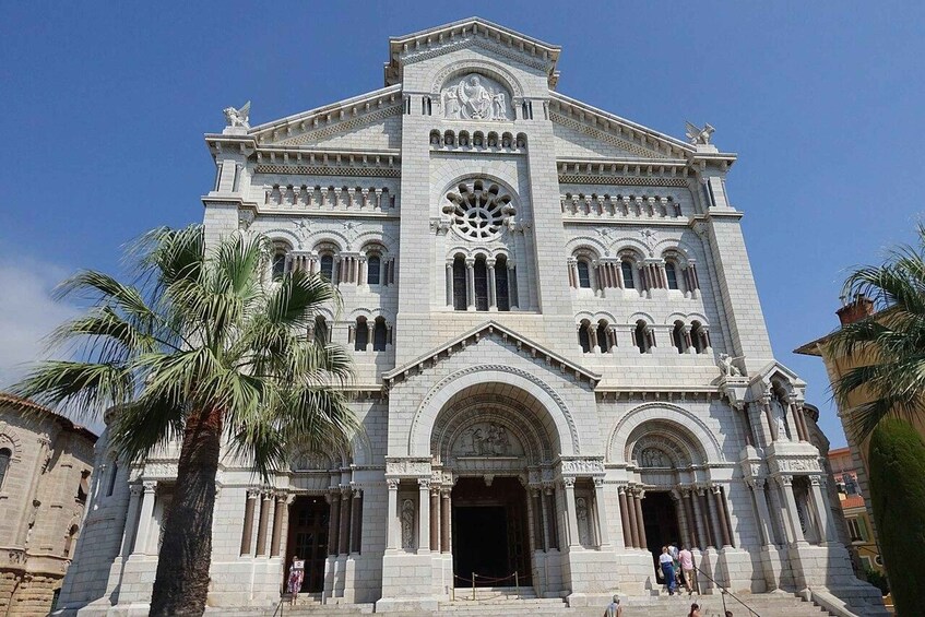 A large, ornate church with a prominent clock tower and arched windows. 3