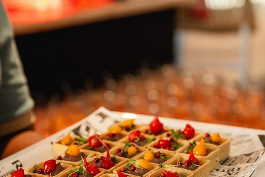 A plate of waffles with fruit and red peppers. 2