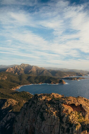 A coastal landscape with rugged mountains and a clear sky. 2