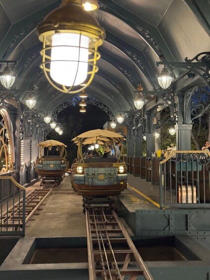 A tram station with vintage-style trams and ornate lighting fixtures. 2