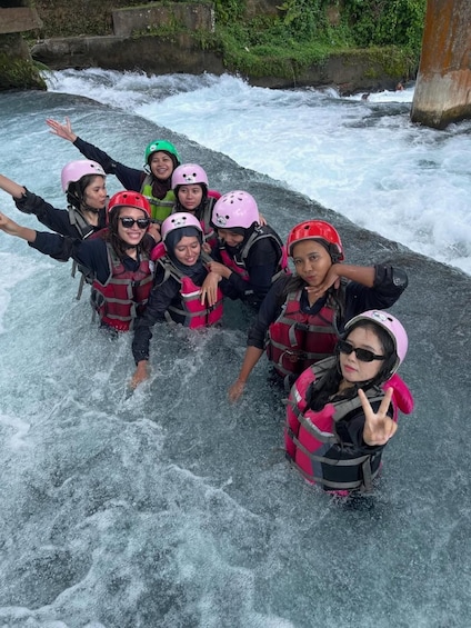 A group of people rafting on a river with rapids. 4