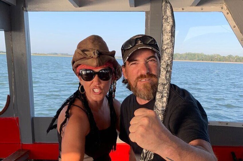 Two people on a boat holding a fishing rod. 3