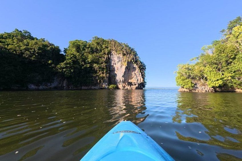 A kayak on calm water with cliffs on either side. 4