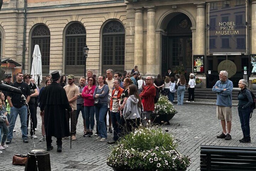 A group of people standing in front of the Nobel Prize Museum. 4