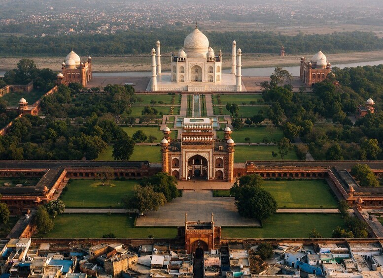 The Taj Mahal with its four minarets, a large central dome, and a symmetrical garden layout. 1