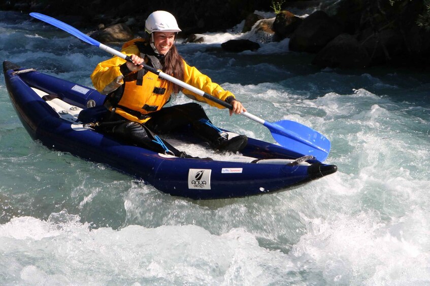 A person kayaking on a river. 2