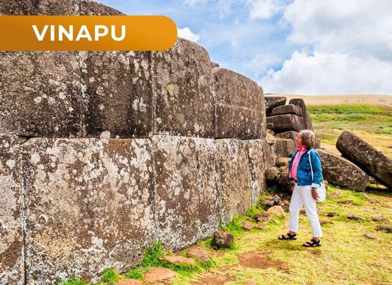 A person standing near ancient stone ruins with the text 'VINAPU' indicating the location. 3