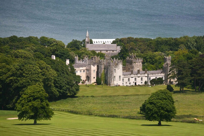 A historic castle surrounded by lush greenery and a golf course. 4