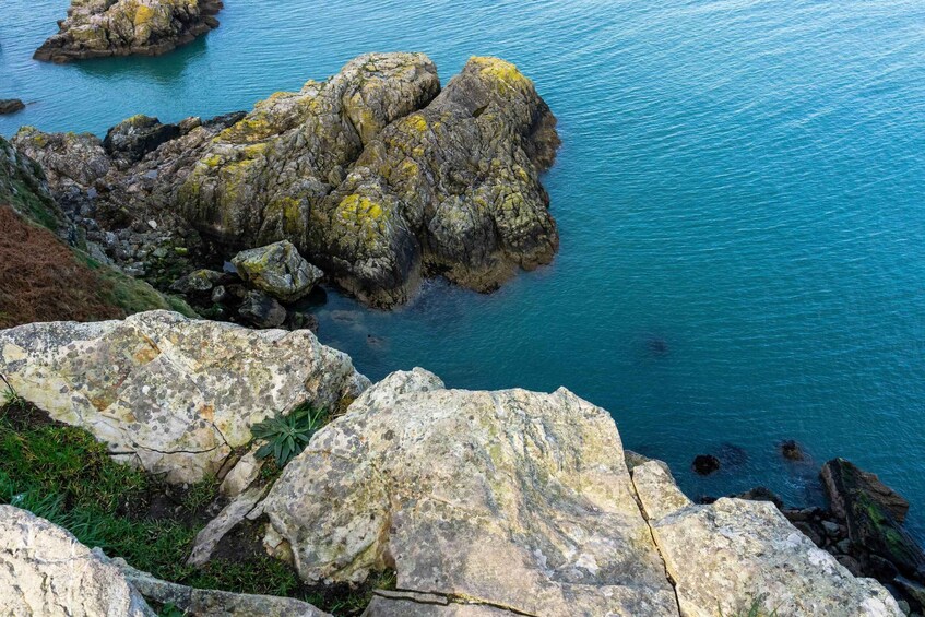 A rocky coastline with clear blue water. 3
