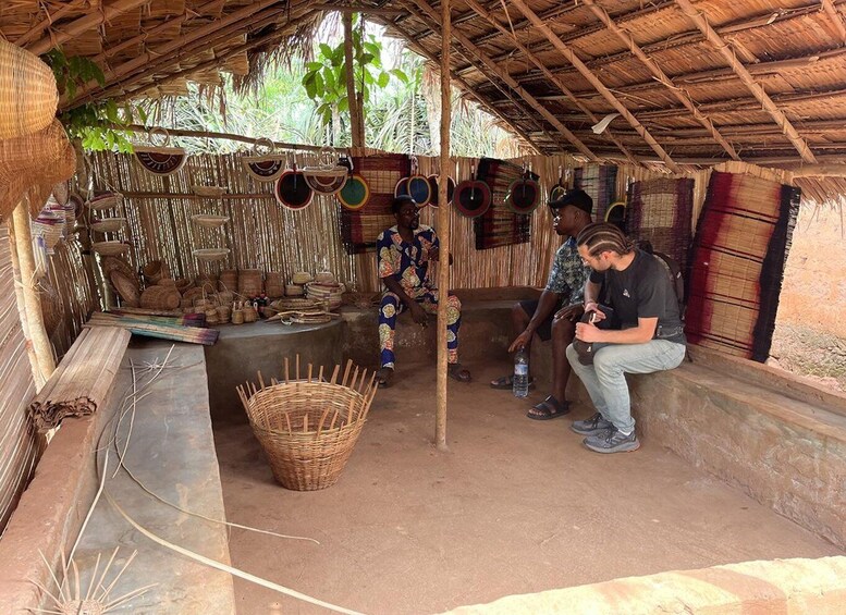 A rustic outdoor market with woven baskets and colorful woven mats. 4
