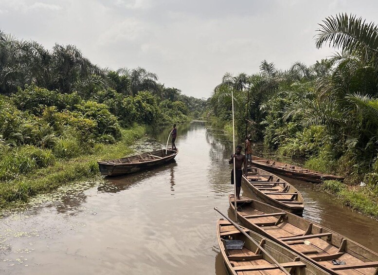 A calm river with boats docked along the banks, surrounded by dense greenery. 3