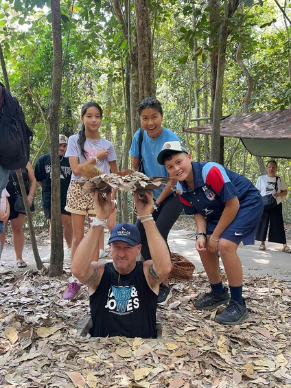 A group of people in a forested area, some holding a large bird of prey. 4